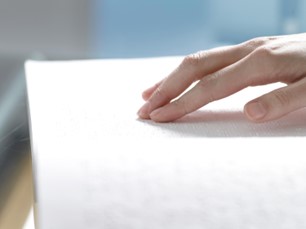 A photo of someone reading Braille.