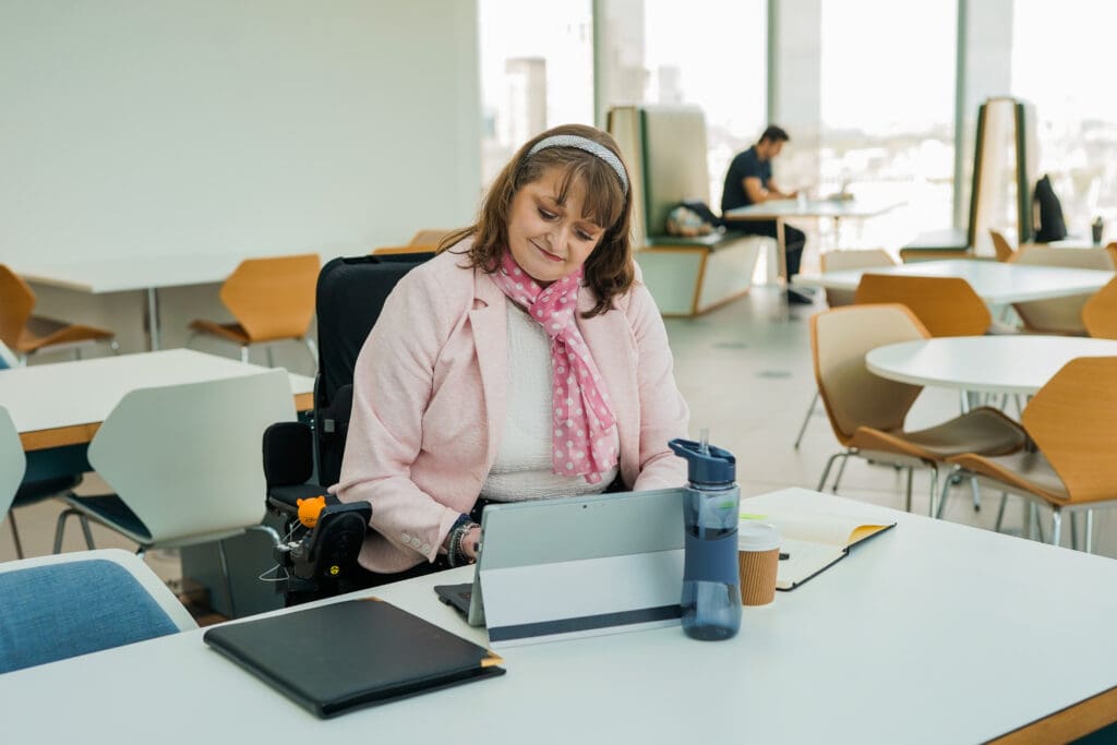 View all results A wheelchair user working from a laptop at an office desk