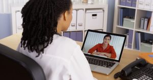 A woman video calling someone at a desk