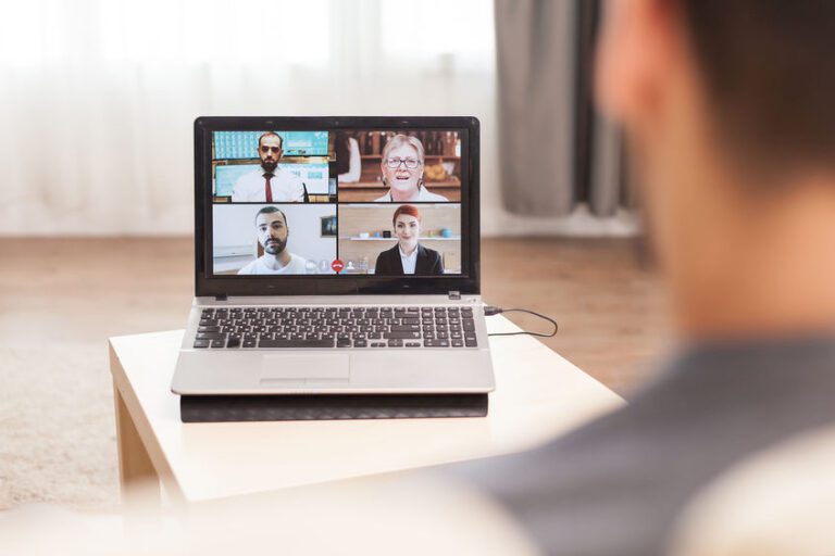 Businessman in a video conference with his team while working from home during quarantine.