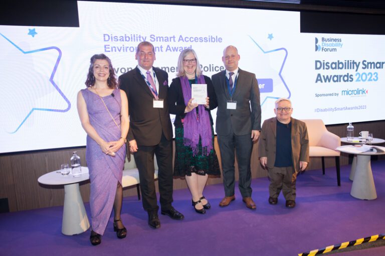 The Avon & Somerset Police team posing with their award on stage at the Disability Smart Awards 2023 ceremony.