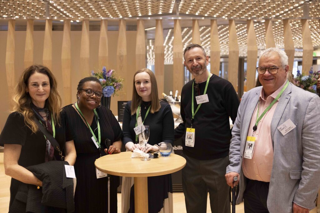 5 delegates pose together in the reception area of the Disability Smart Awards 2024 ceremony.