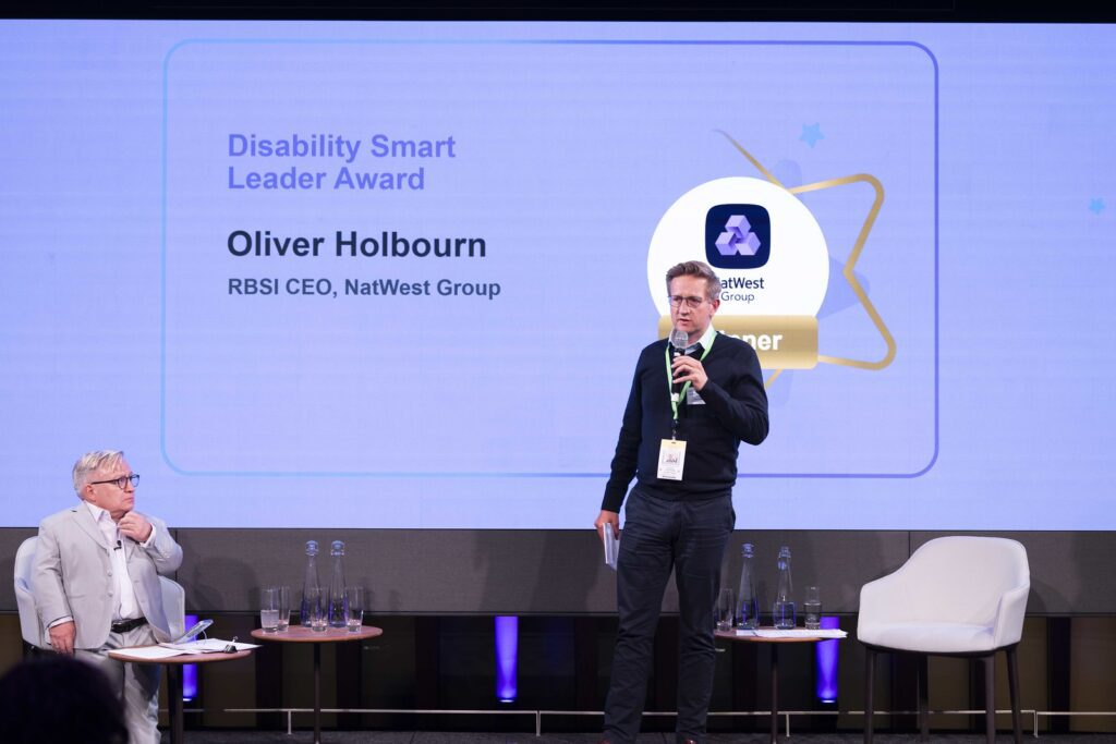 A winner gives a speech on stage at the Disability Smart Awards 2024 ceremony.