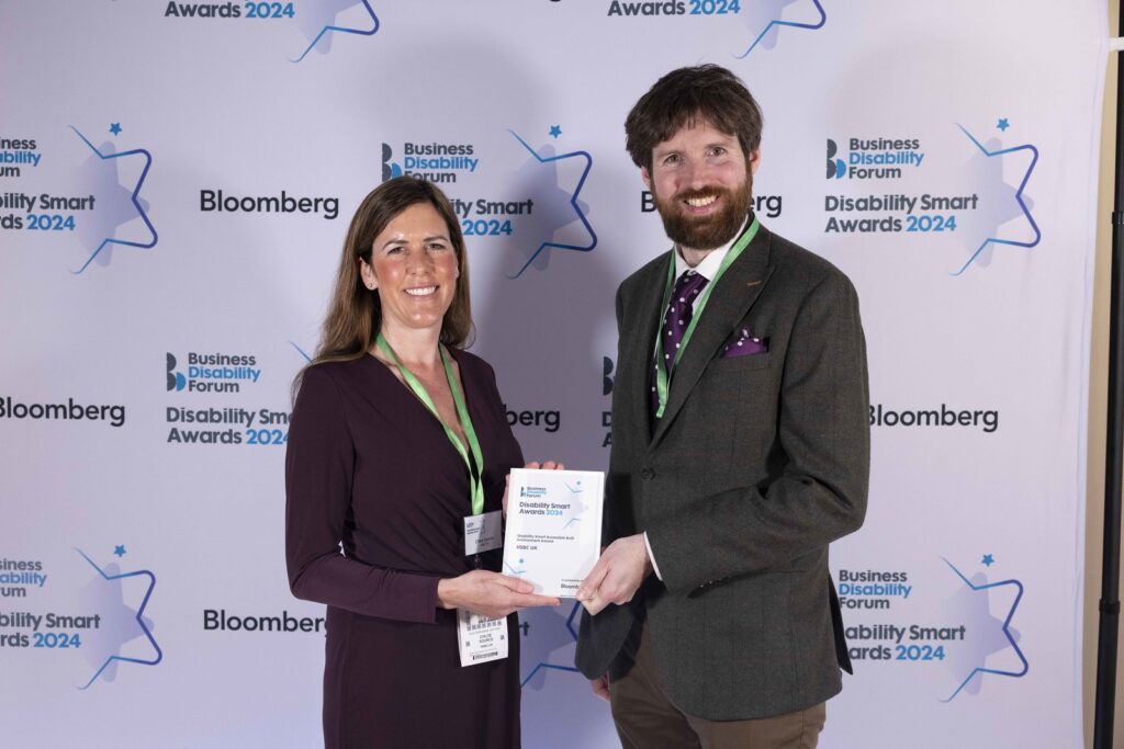 Two winners pose with their award at the Disability Smart Awards 2024 ceremony.