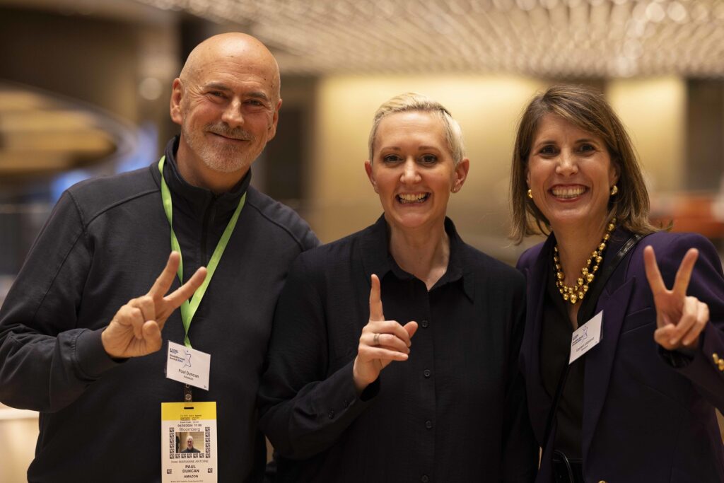 3 delegates pose together and smile in the reception area of the Disability Smart Awards 2024 ceremony.