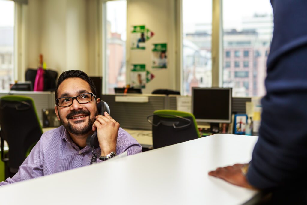 A man using a landline phone in an office