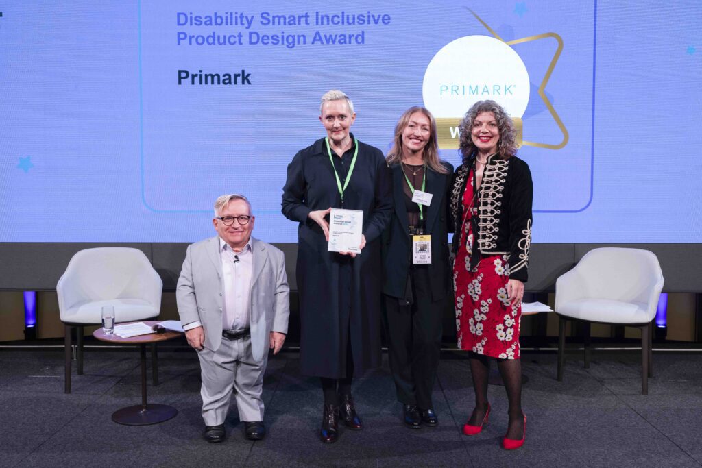 The Primark team posing with their award on stage with co-hosts Diane Lightfoot and Simon Minty at the Disability Smart Awards 2024 ceremony.