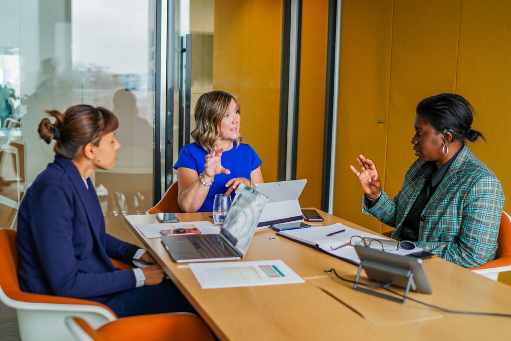 Group of people with diverse disabilities in a work meeting.