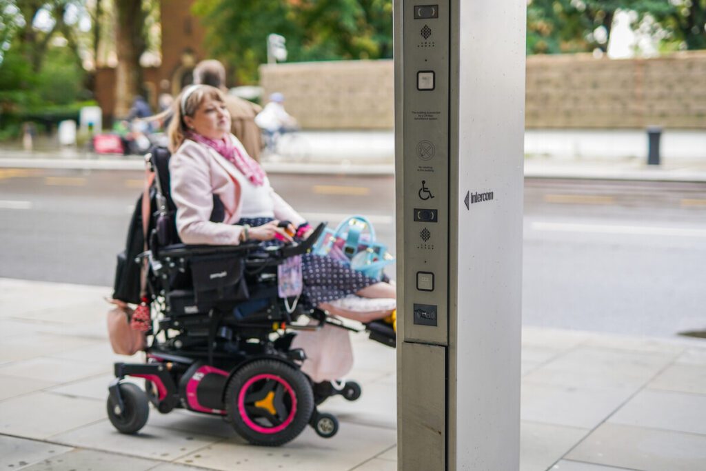 Someone using a wheelchair on a pavement.