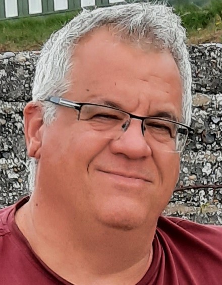 Headshot of Alan Collins, a white man with short salt-and-pepper hair and glasses.