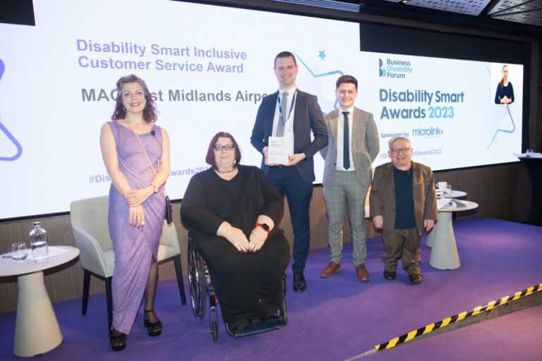 The Procter & Gamble team posing with their award on stage at the Disability Smart Awards 2023 ceremony.