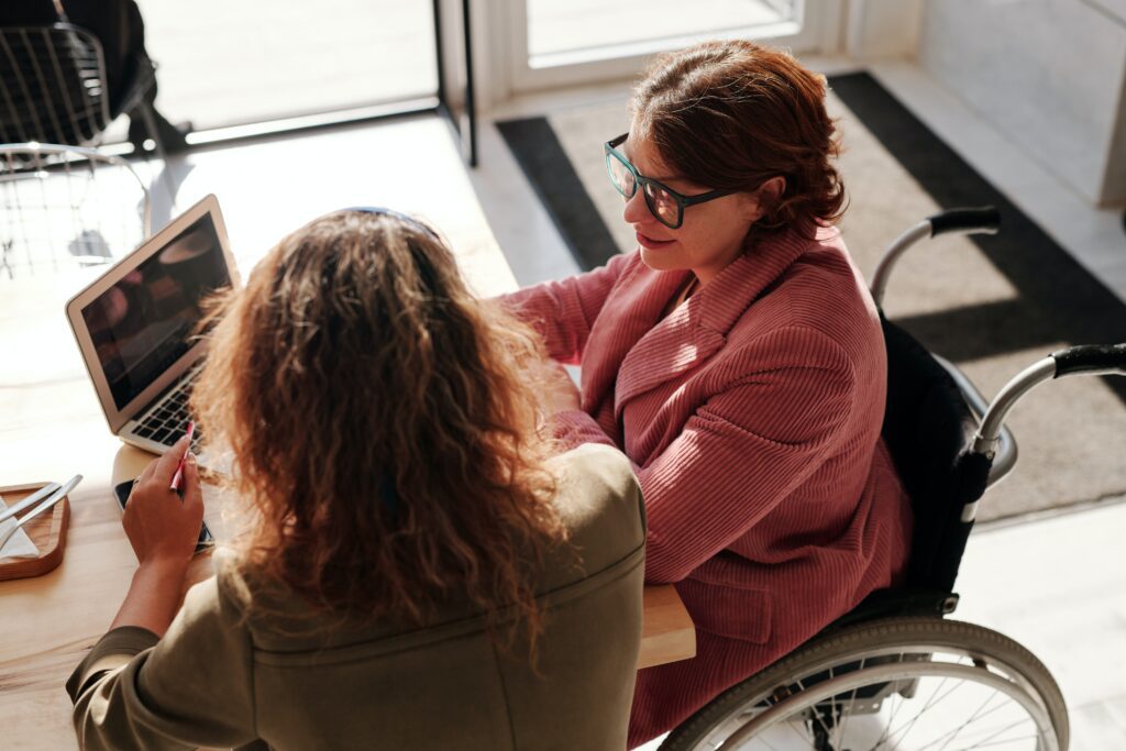 Woman in wheelchair attending a meeting