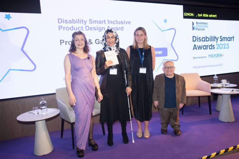 The Procter & Gamble team posing with their award on stage at the Disability Smart Awards 2023 ceremony.