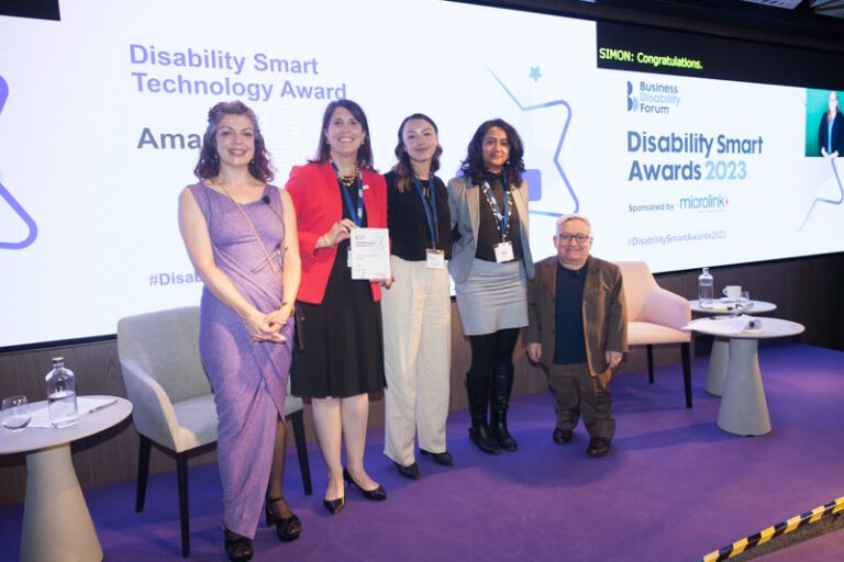 The Amazon team posing with their award on stage at the Disability Smart Awards 2023 ceremony.